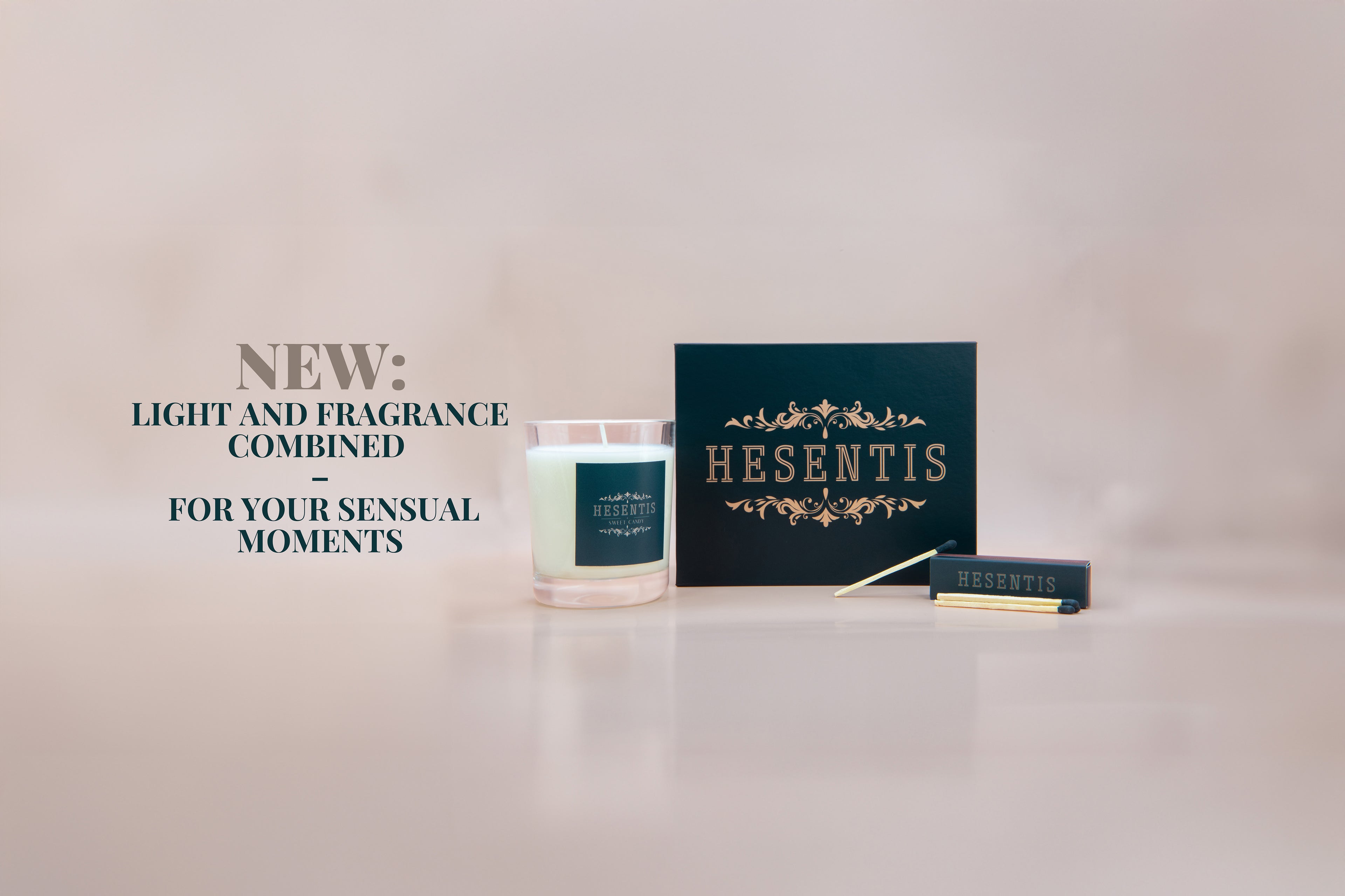 Elegant gift box from Hesentis with scented candle accompanied by matches, presented on a neutral background.